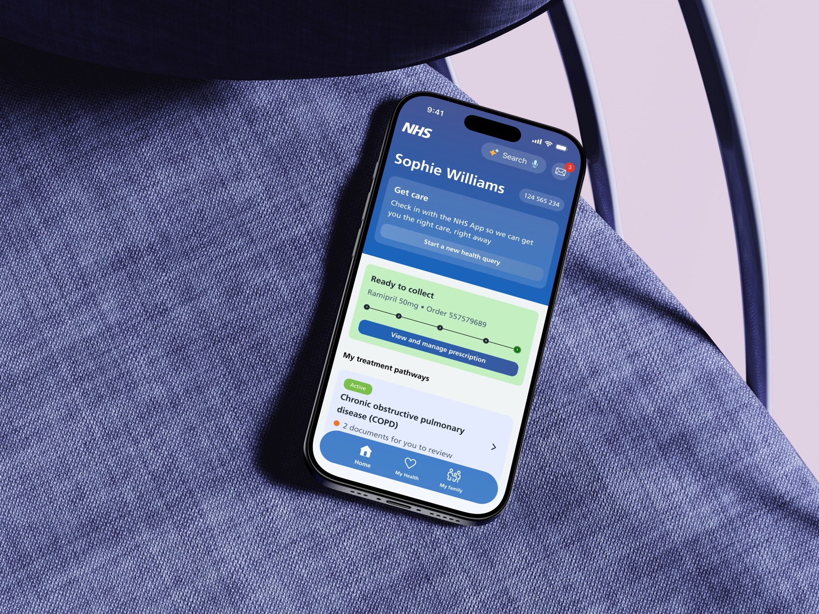 The NHS App shown on a phone, resting on a chair